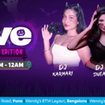 Halloween-themed Wendy’s diner with devil horn headbands, DJ setup, customers enjoying unlimited burgers and spooky décor in Bangalore